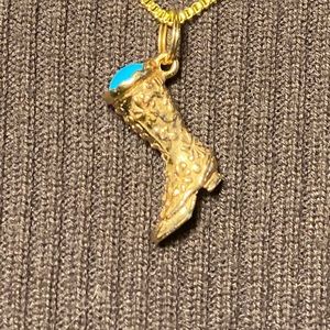Avon 1973 cowboy boot pendant on 20-inch chain. Gold tone.